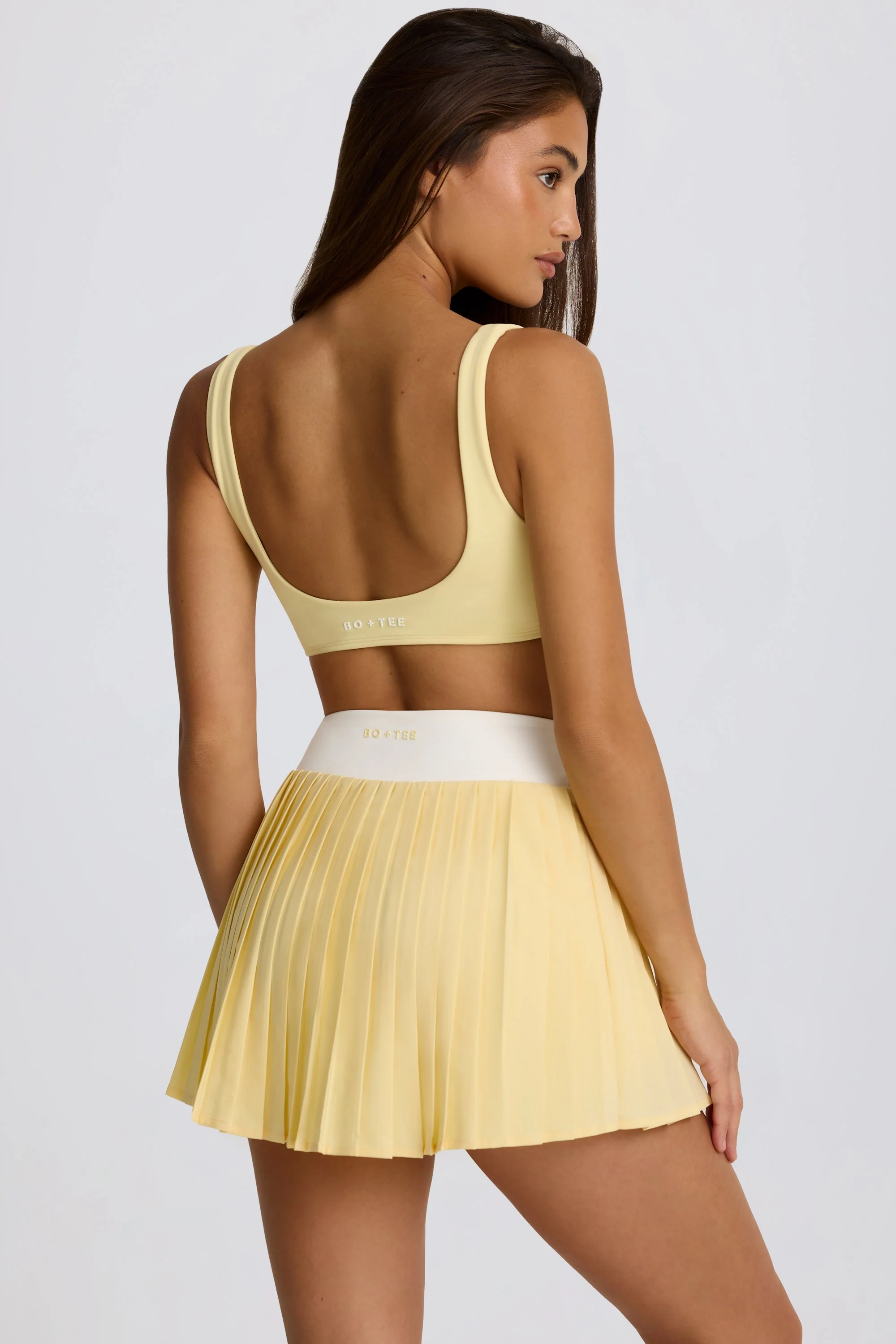 Soft Active Crossover Pleated Mini Skort in Lemon - Image 2